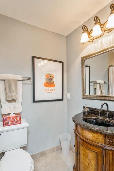 1230 South Drive Way, Unit A Delray Beach, FL 33445 - Photo 21 of 26 a bathroom with a granite countertop toilet sink and mirror