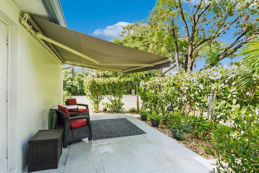 1230 South Drive Way, Unit A Delray Beach, FL 33445 - Photo 24 of 26 a backyard of a house with outdoor seating