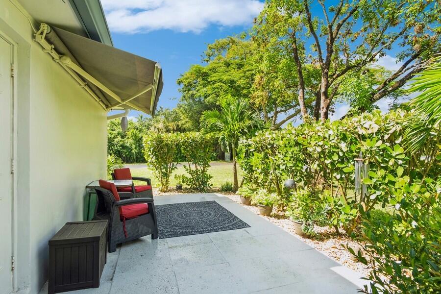 1230 South Drive Way, Unit A Delray Beach, FL 33445 - Photo 25 of 26 a backyard of a house with outdoor seating