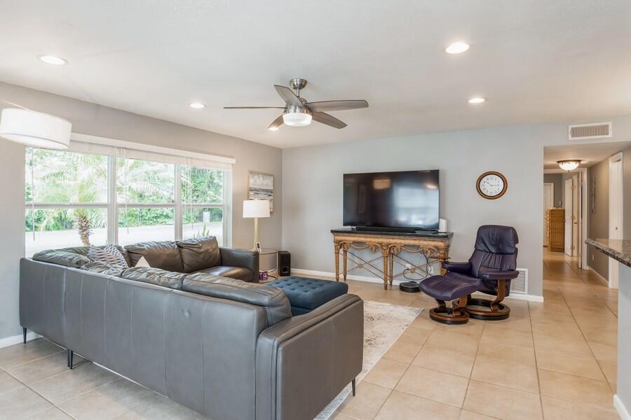1230 South Drive Way, Unit A Delray Beach, FL 33445 - Photo 4 of 26 a living room with furniture and a flat screen tv