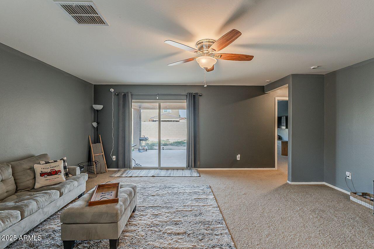 8721 South 253rd Drive Buckeye, AZ 85326 - Photo 15 of 44 a living room with furniture and a chandelier