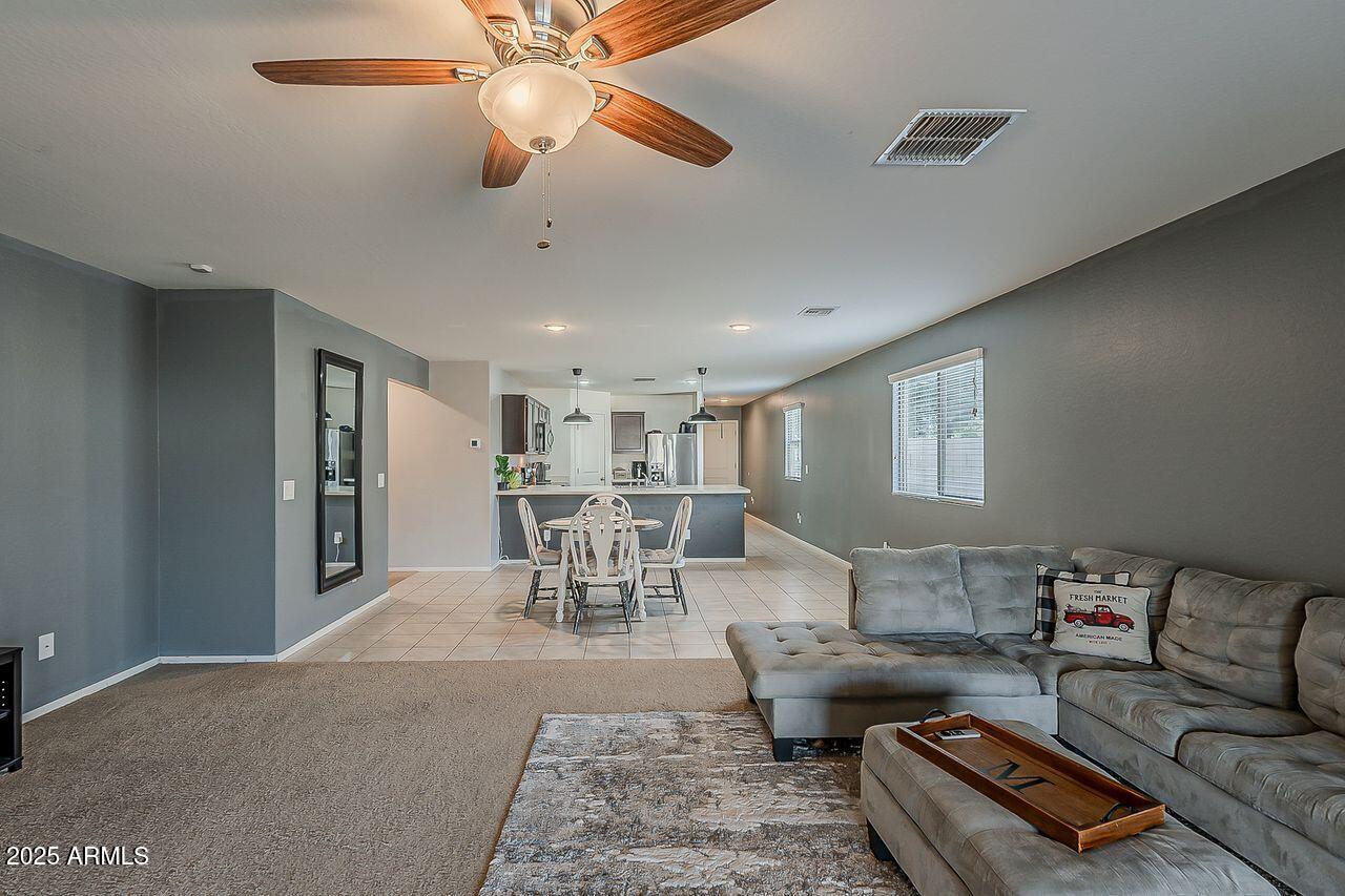 8721 South 253rd Drive Buckeye, AZ 85326 - Photo 16 of 44 a living room with furniture and a large window