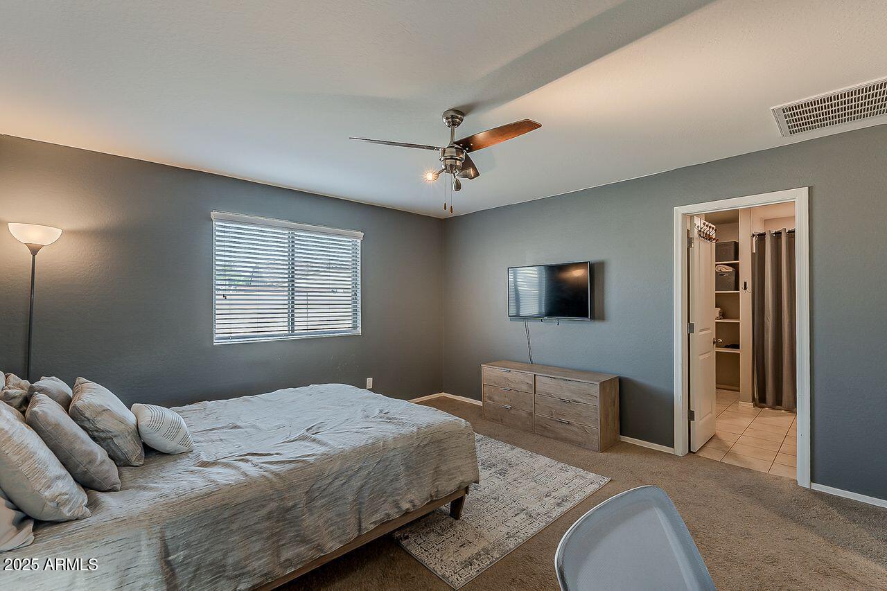 8721 South 253rd Drive Buckeye, AZ 85326 - Photo 21 of 44 a bedroom with a bed and wooden floor