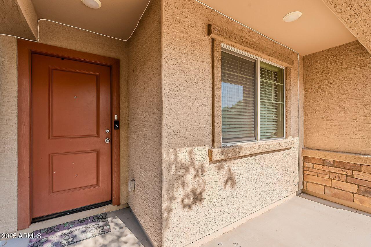 8721 South 253rd Drive Buckeye, AZ 85326 - Photo 3 of 44 a view of a closet area with wooden floor
