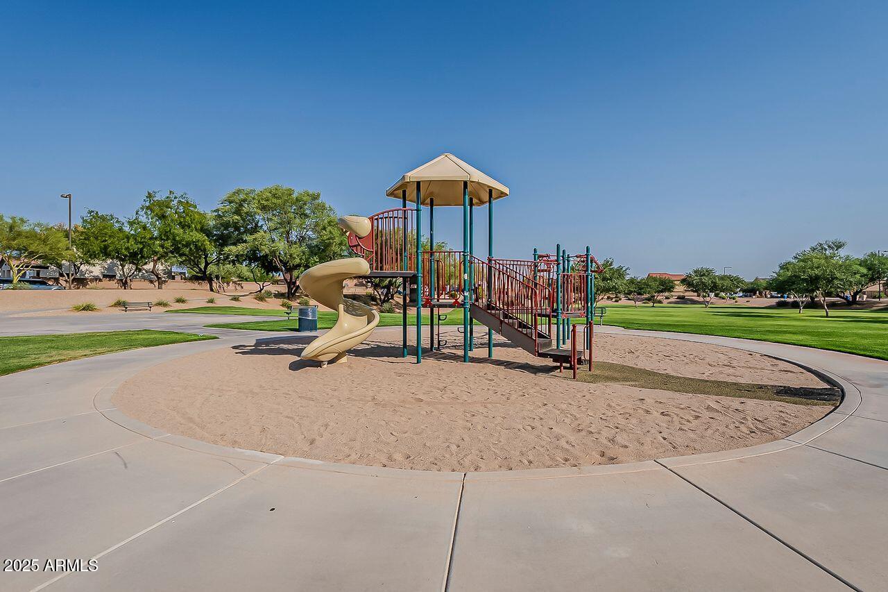 8721 South 253rd Drive Buckeye, AZ 85326 - Photo 39 of 44 a wooden bench sitting in the middle of a park