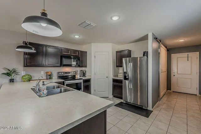 a kitchen with sink cabinets and stainless steel appliances
