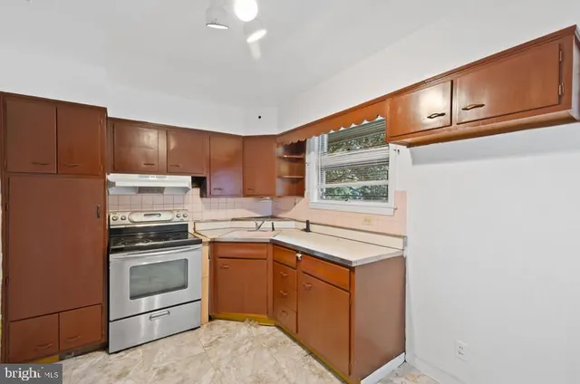 a kitchen with a sink stove and microwave
