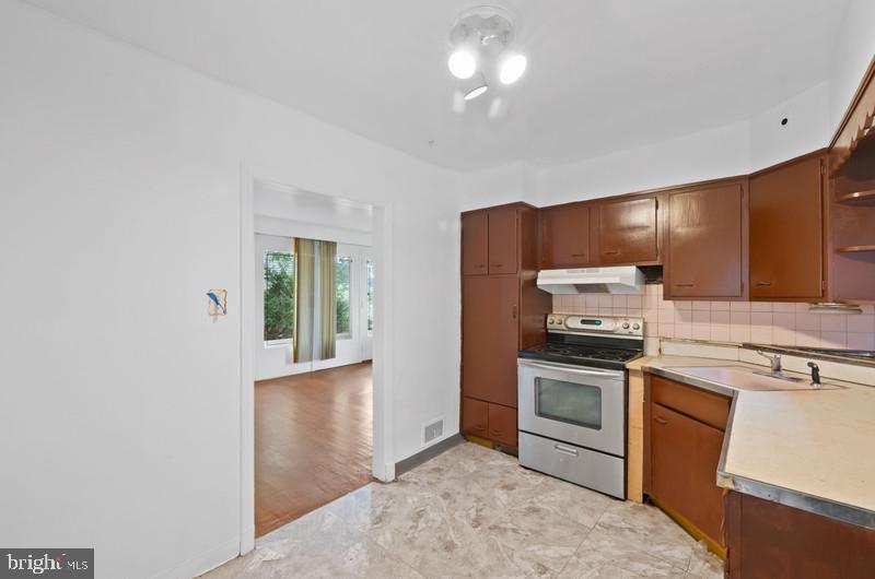 4109 Westview Road Baltimore, MD 21218 - Photo 13 of 35 a kitchen with stainless steel appliances granite countertop a stove and a refrigerator