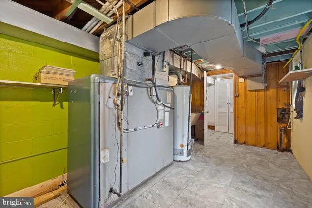 an aerial view of a house with outdoor space and trees all around
