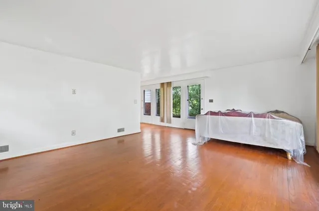 a view of room with hardwood floor and cabinet
