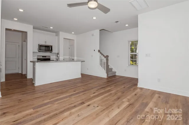 a kitchen with stainless steel appliances granite countertop a stove a sink and a refrigerator