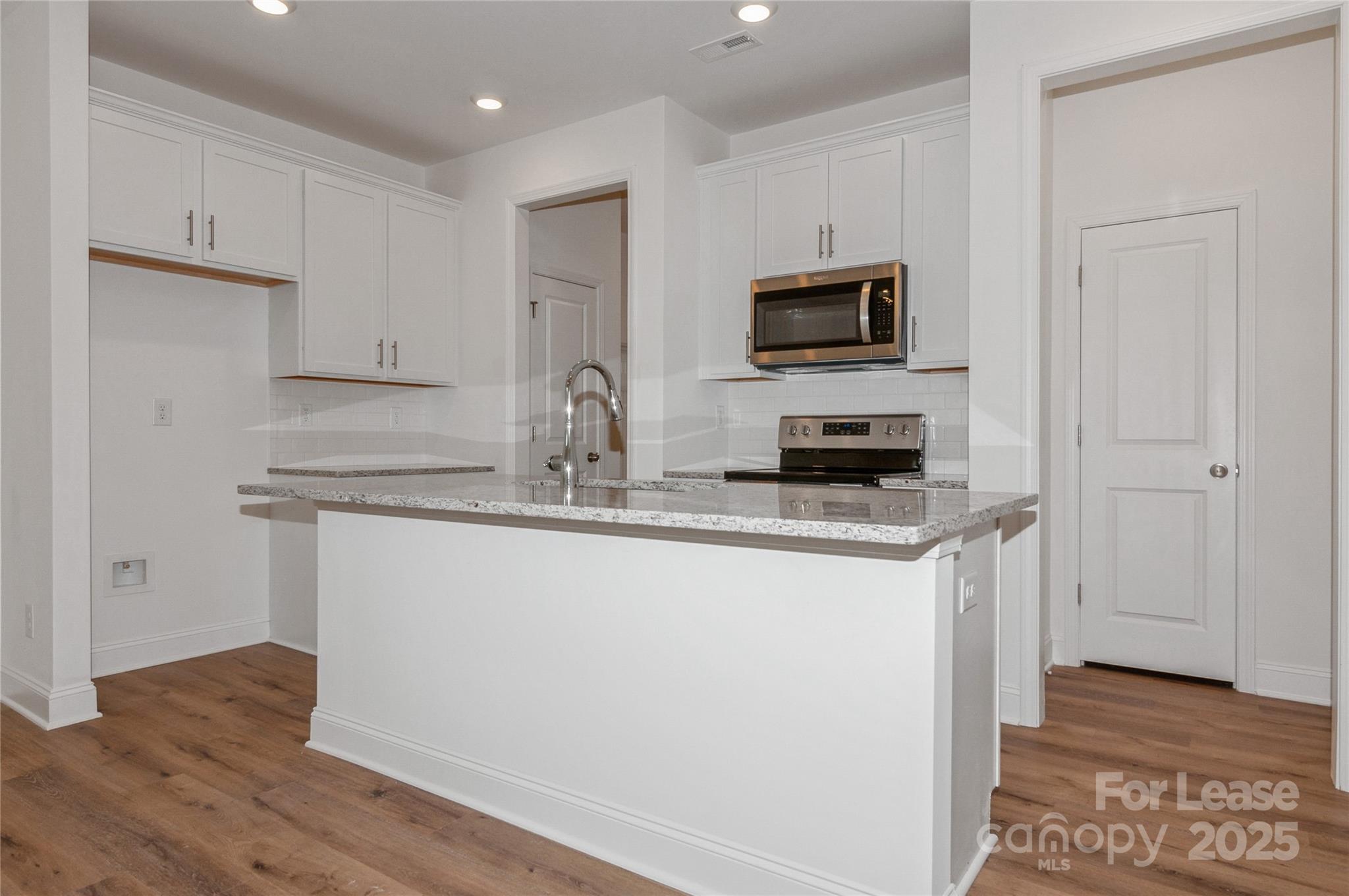 6006 Cedar Chip Way Matthews, NC 28105 - Photo 15 of 35 a kitchen with stainless steel appliances granite countertop a stove a sink and a refrigerator