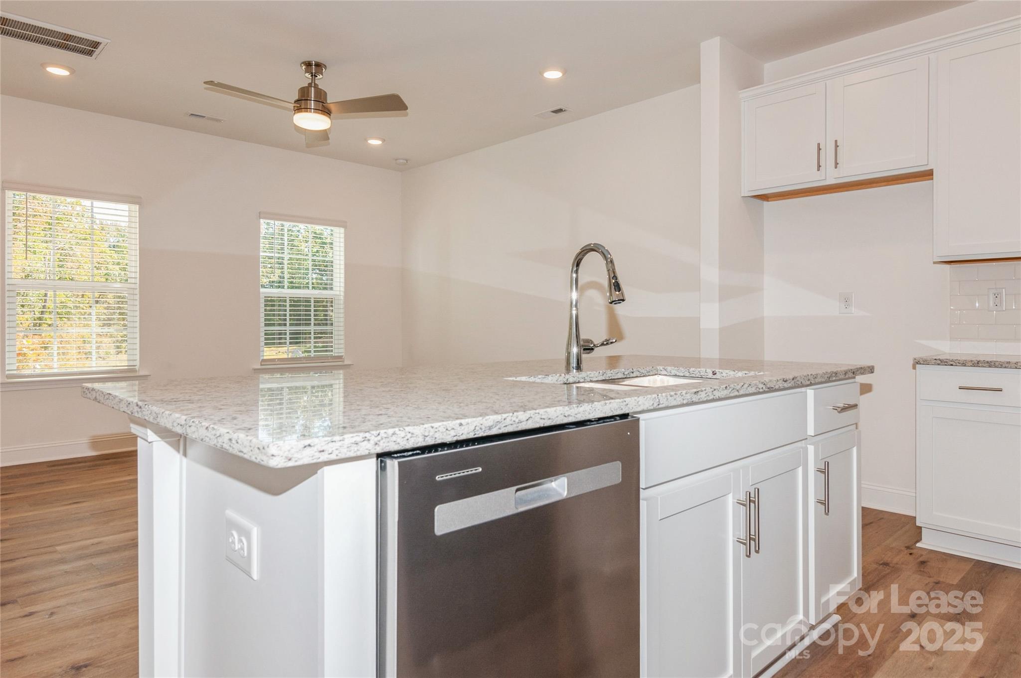6006 Cedar Chip Way Matthews, NC 28105 - Photo 18 of 35 a kitchen with stainless steel appliances granite countertop a sink a stove and a refrigerator