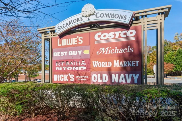 a large kitchen with stainless steel appliances a large counter top a stove and a refrigerator