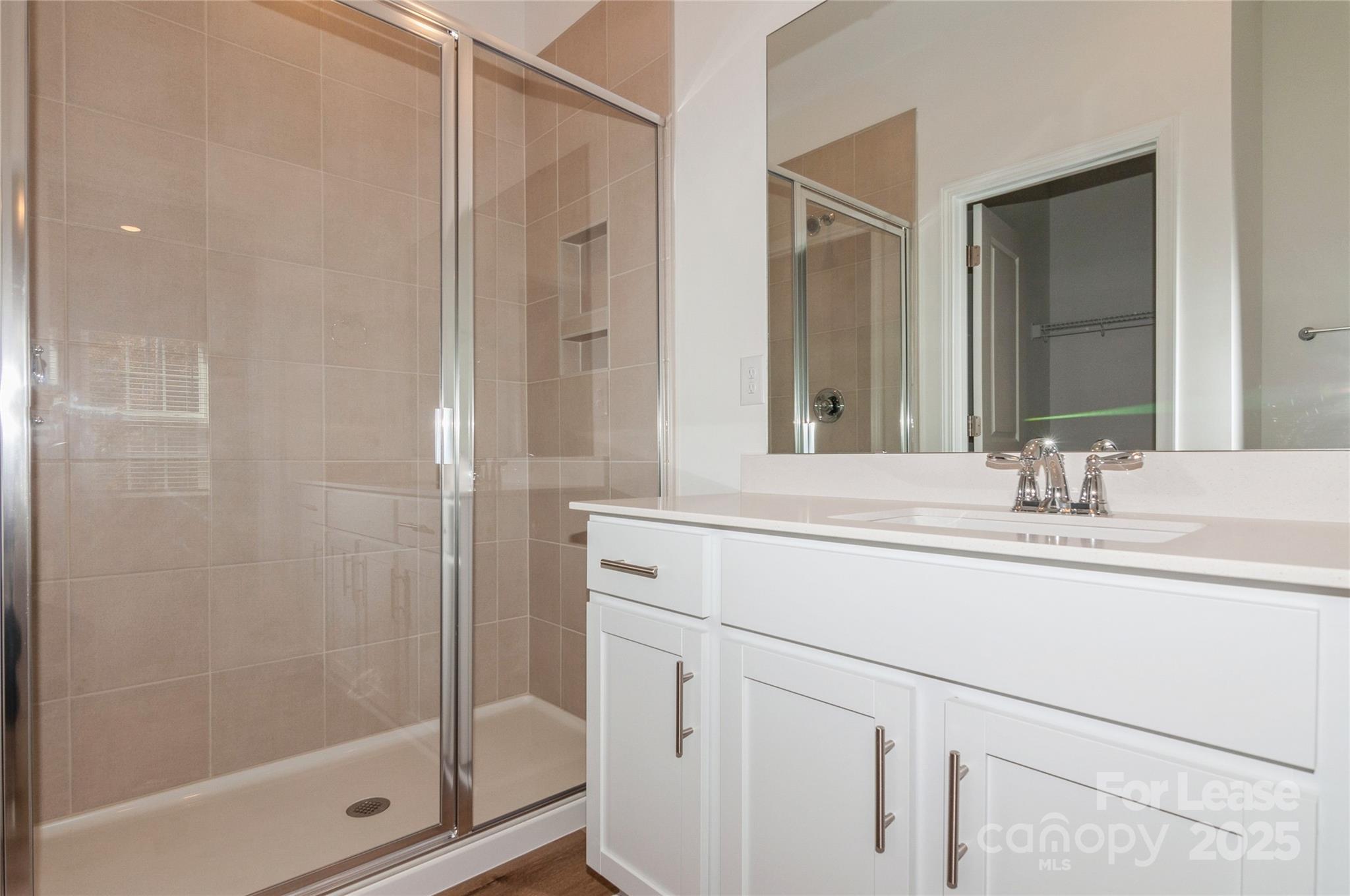 6006 Cedar Chip Way Matthews, NC 28105 - Photo 22 of 35 a bathroom with a shower sink and mirror