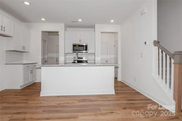 a kitchen with a sink and a microwave