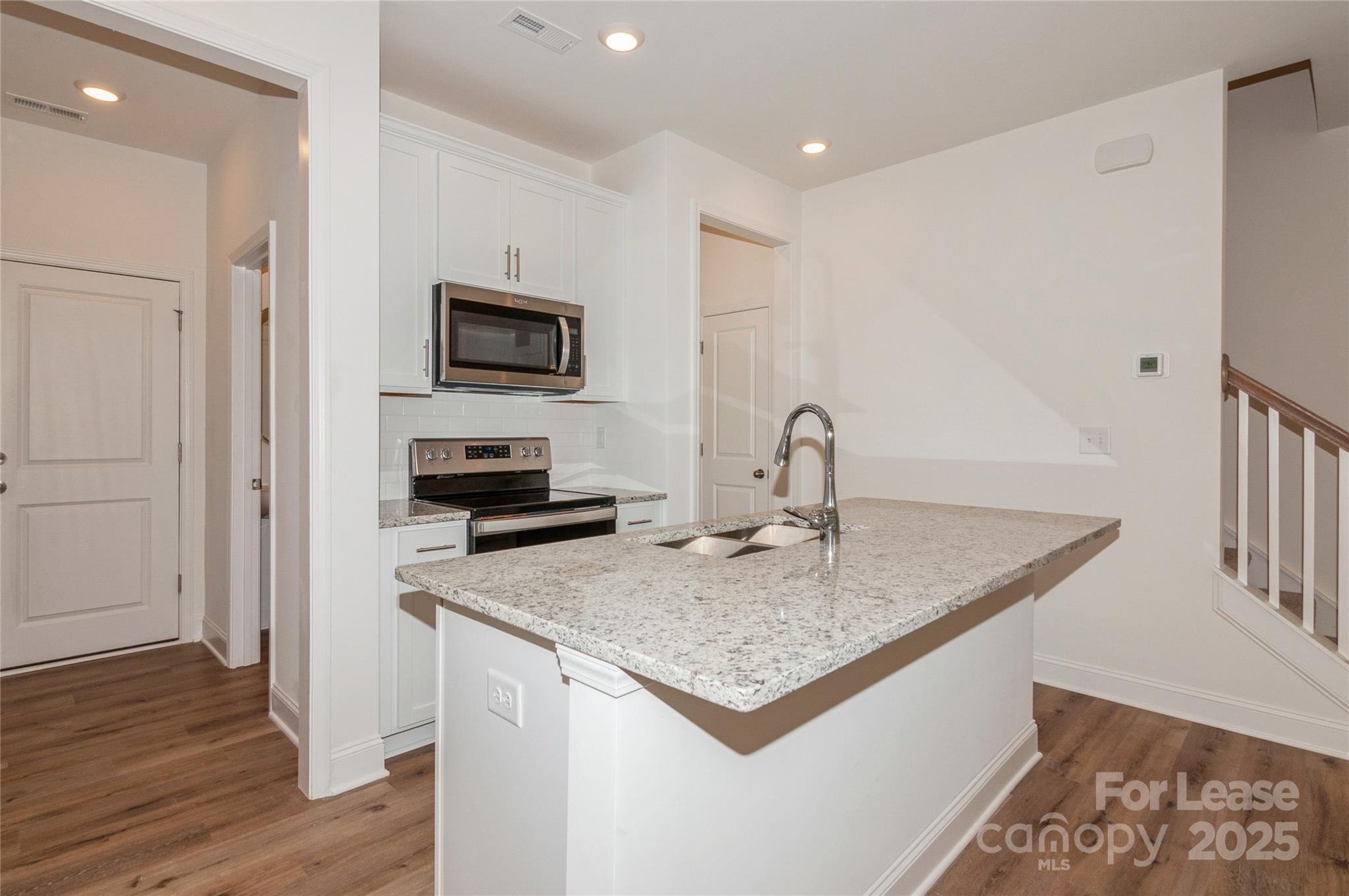 6006 Cedar Chip Way Matthews, NC 28105 - Photo 4 of 35 a kitchen with a sink and a microwave