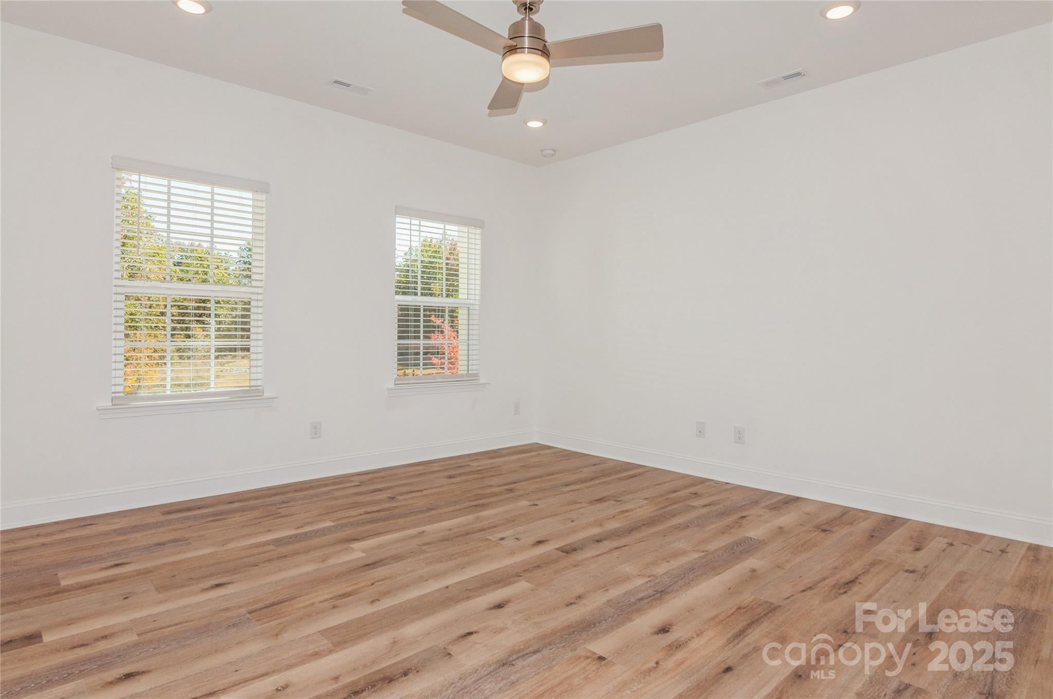 6006 Cedar Chip Way Matthews, NC 28105 - Photo 5 of 35 wooden floor in an empty room with a window