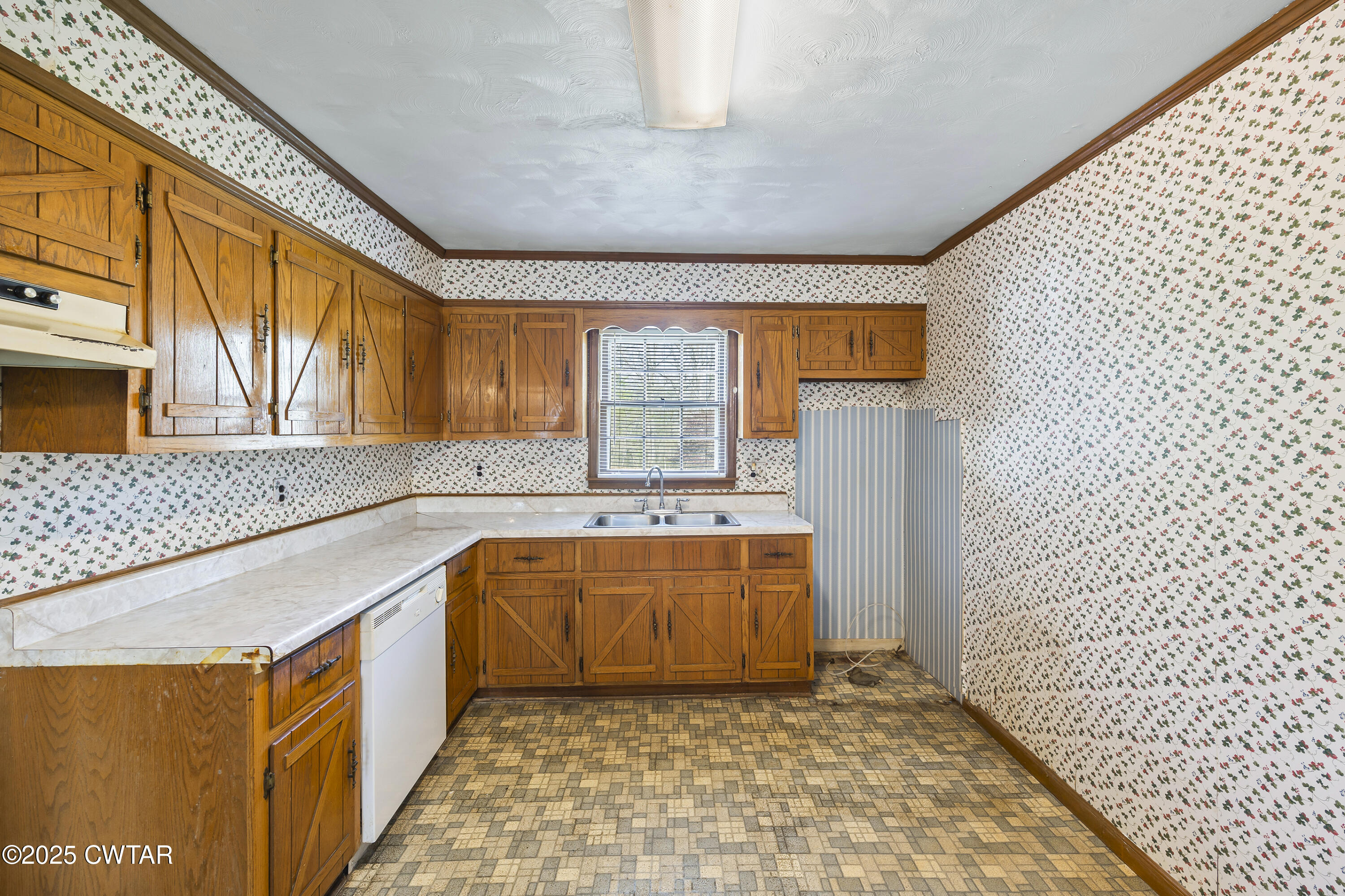 325 Deep Gap Road Jackson, TN 38301 - Photo 7 of 19 a kitchen with a sink a stove cabinets and wooden floor