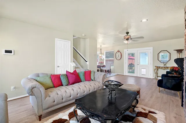 a living room with furniture and wooden floor