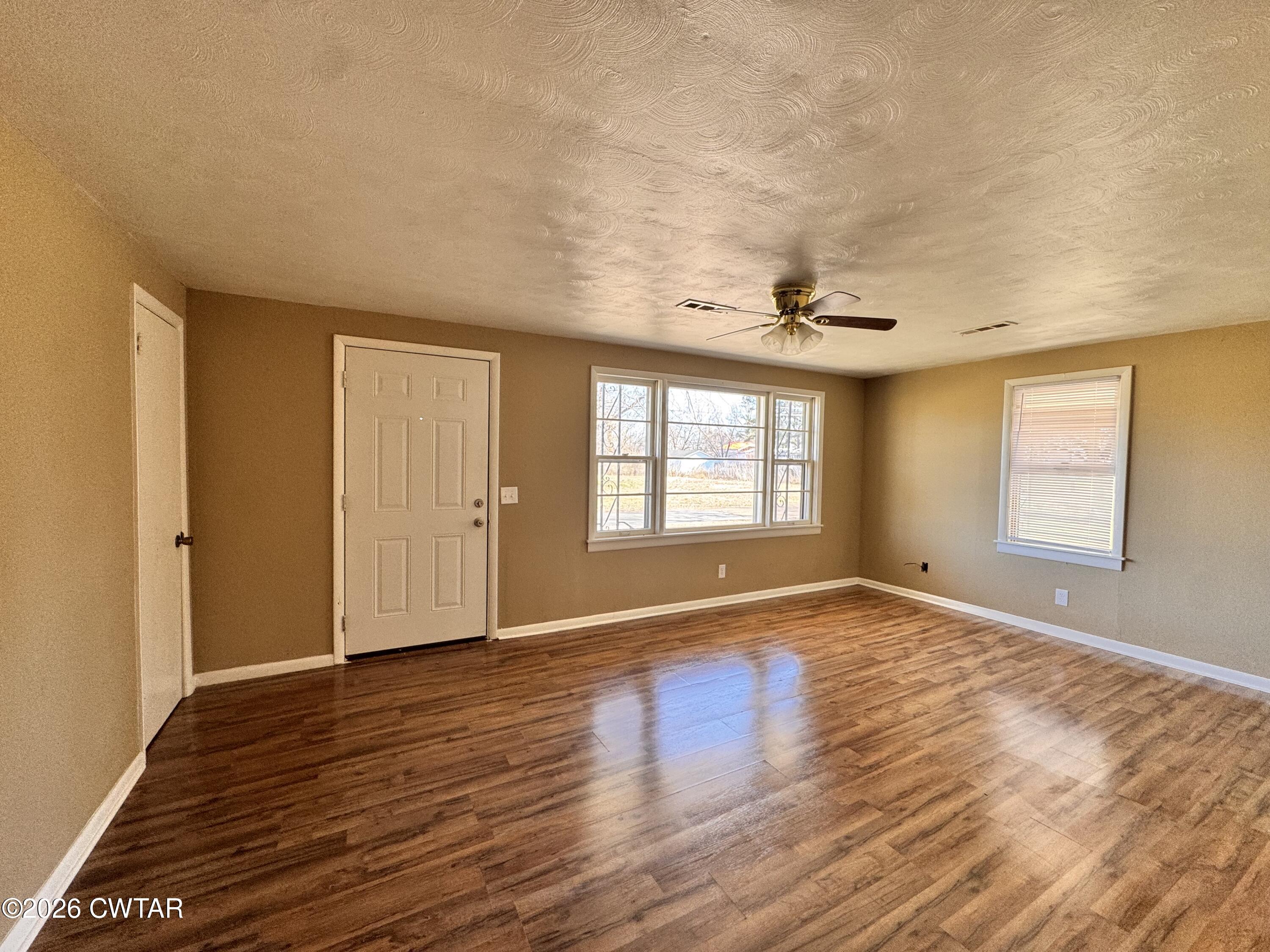 567 North Church Street Rives, TN 38253 - Photo 3 of 17 a view of an empty room with wooden floor and a window