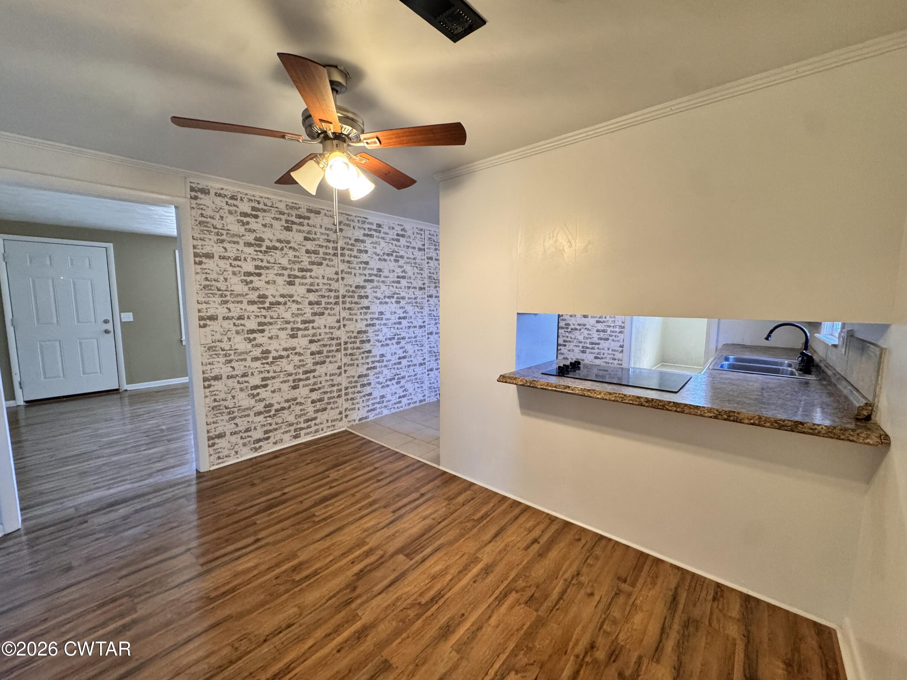 567 North Church Street Rives, TN 38253 - Photo 4 of 17 a room with wooden floor and ceiling fan