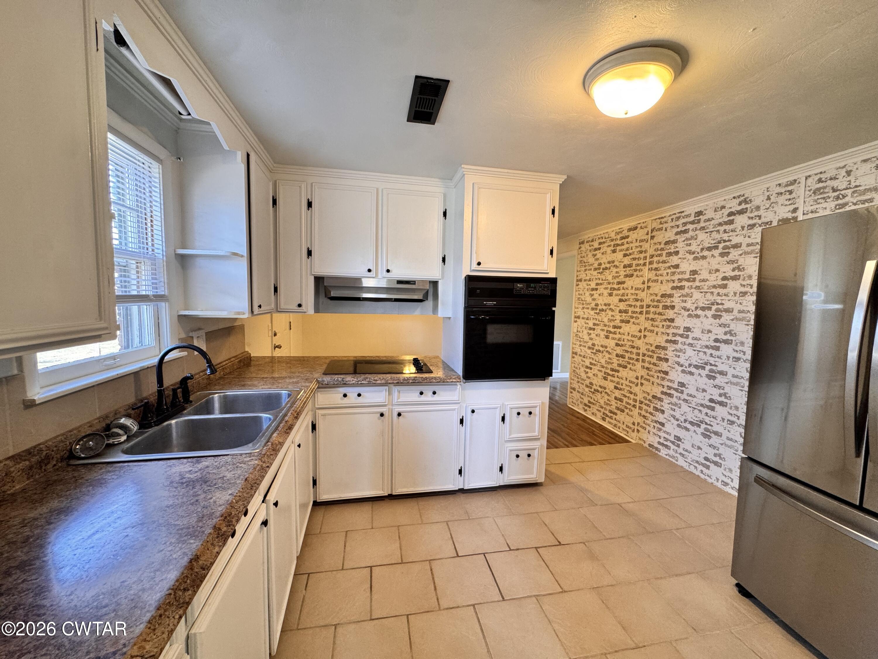 567 North Church Street Rives, TN 38253 - Photo 7 of 17 a kitchen with stainless steel appliances a refrigerator sink and cabinets