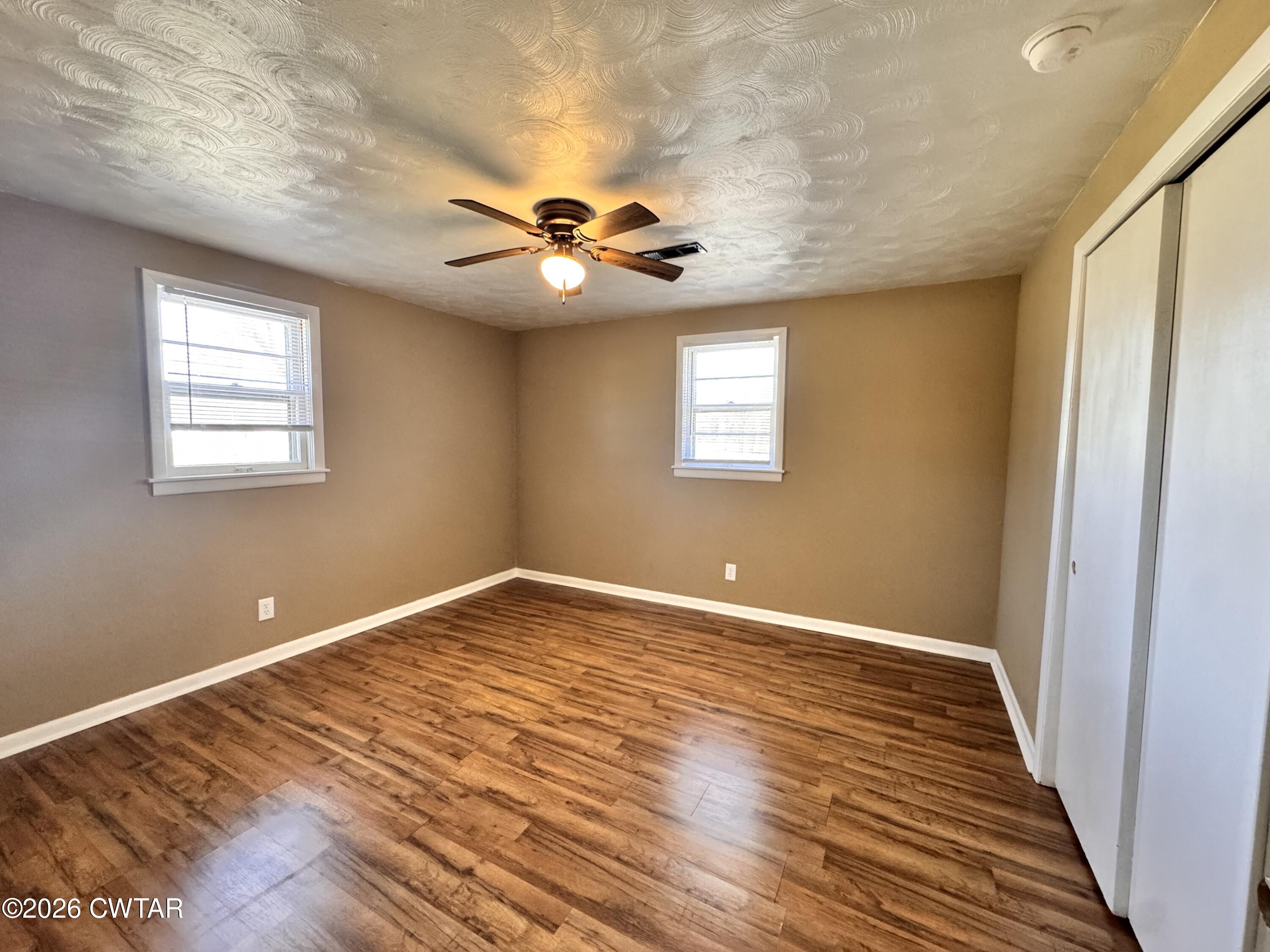 567 North Church Street Rives, TN 38253 - Photo 9 of 17 a view of an empty room with a window and wooden floor