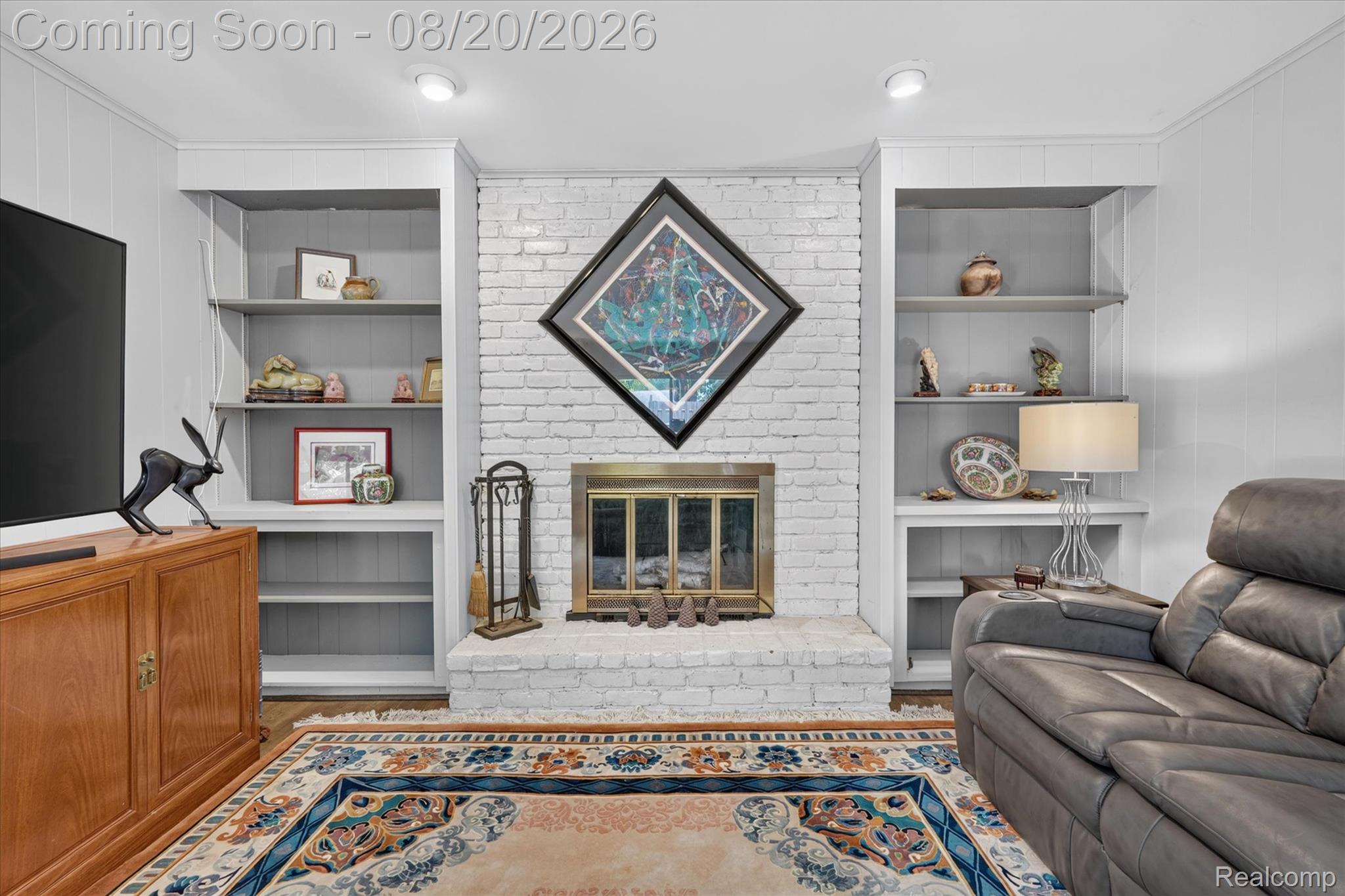 6235 Waldon Road Clarkston, MI 48346 - Photo 14 of 41 Fireplace featuring a painted brick surround, a hearth, and an integrated firebox