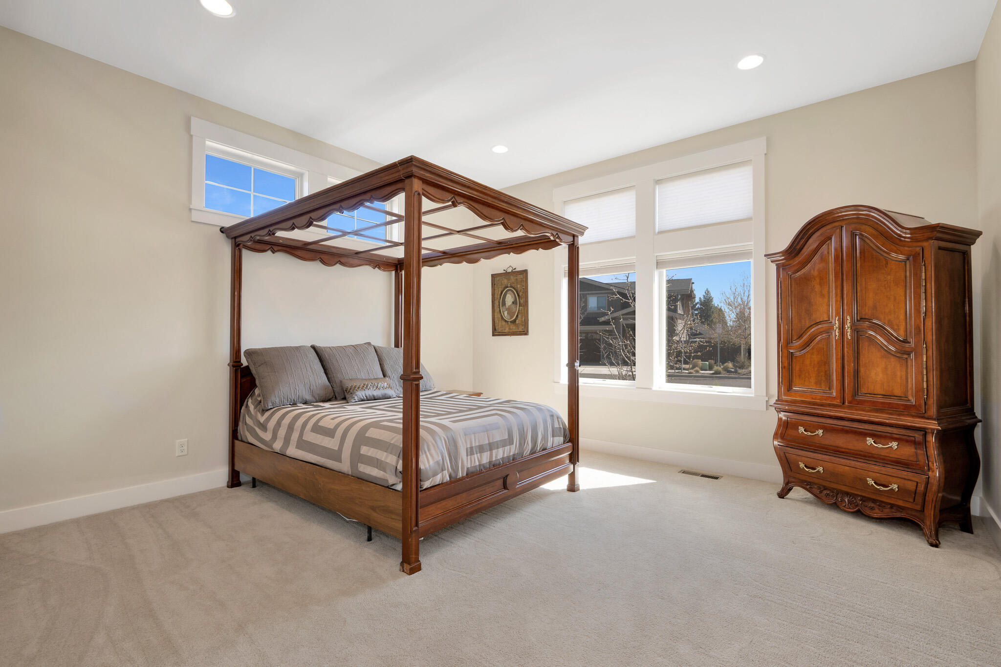 60871 River Rim Drive Bend, OR 97702 - Photo 32 of 42 a spacious bedroom with a bed and a dresser