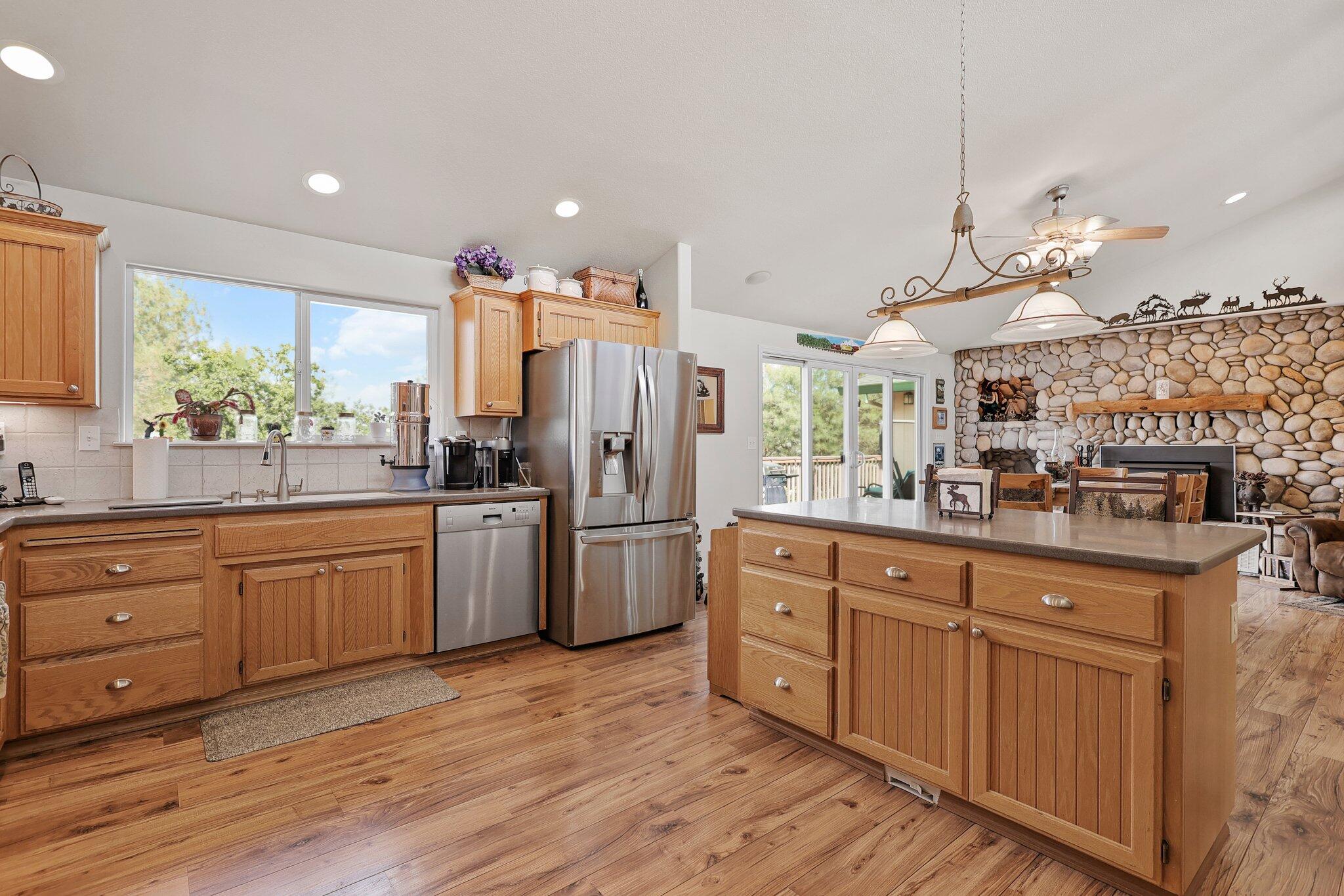 6949 Rector Creek Road Igo, CA 96047 - Photo 17 of 110 a kitchen with stainless steel appliances kitchen island granite countertop a stove a sink and a refrigerator