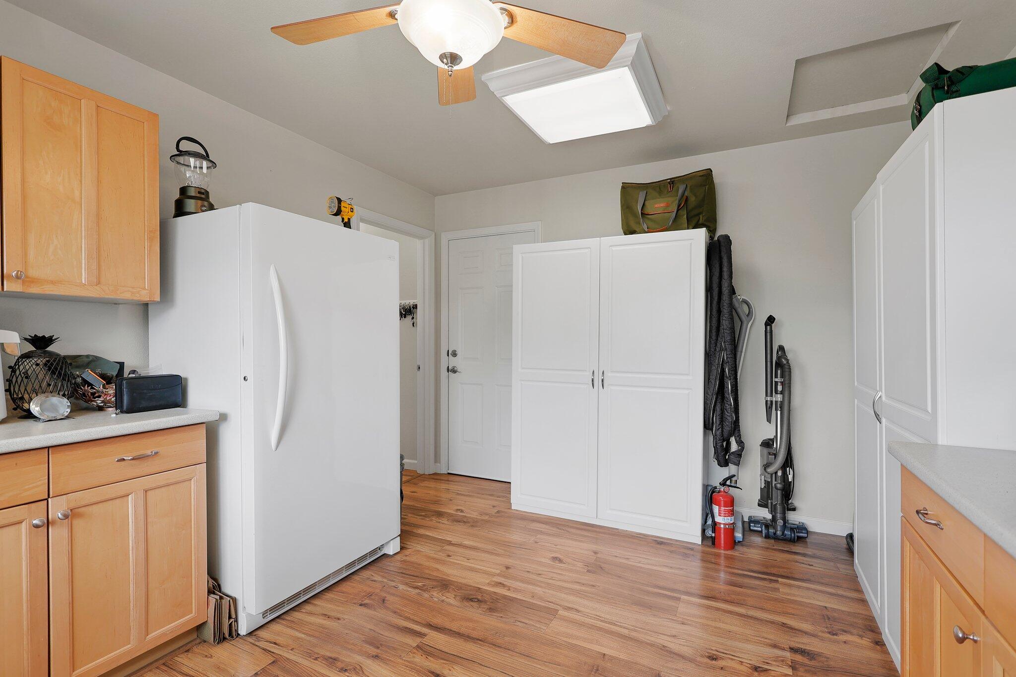 6949 Rector Creek Road Igo, CA 96047 - Photo 21 of 110 a view of a kitchen with refrigerator and wooden floor