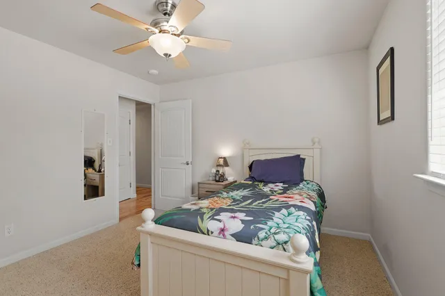 a kitchen with stainless steel appliances granite countertop a refrigerator a stove and a sink with wooden floor