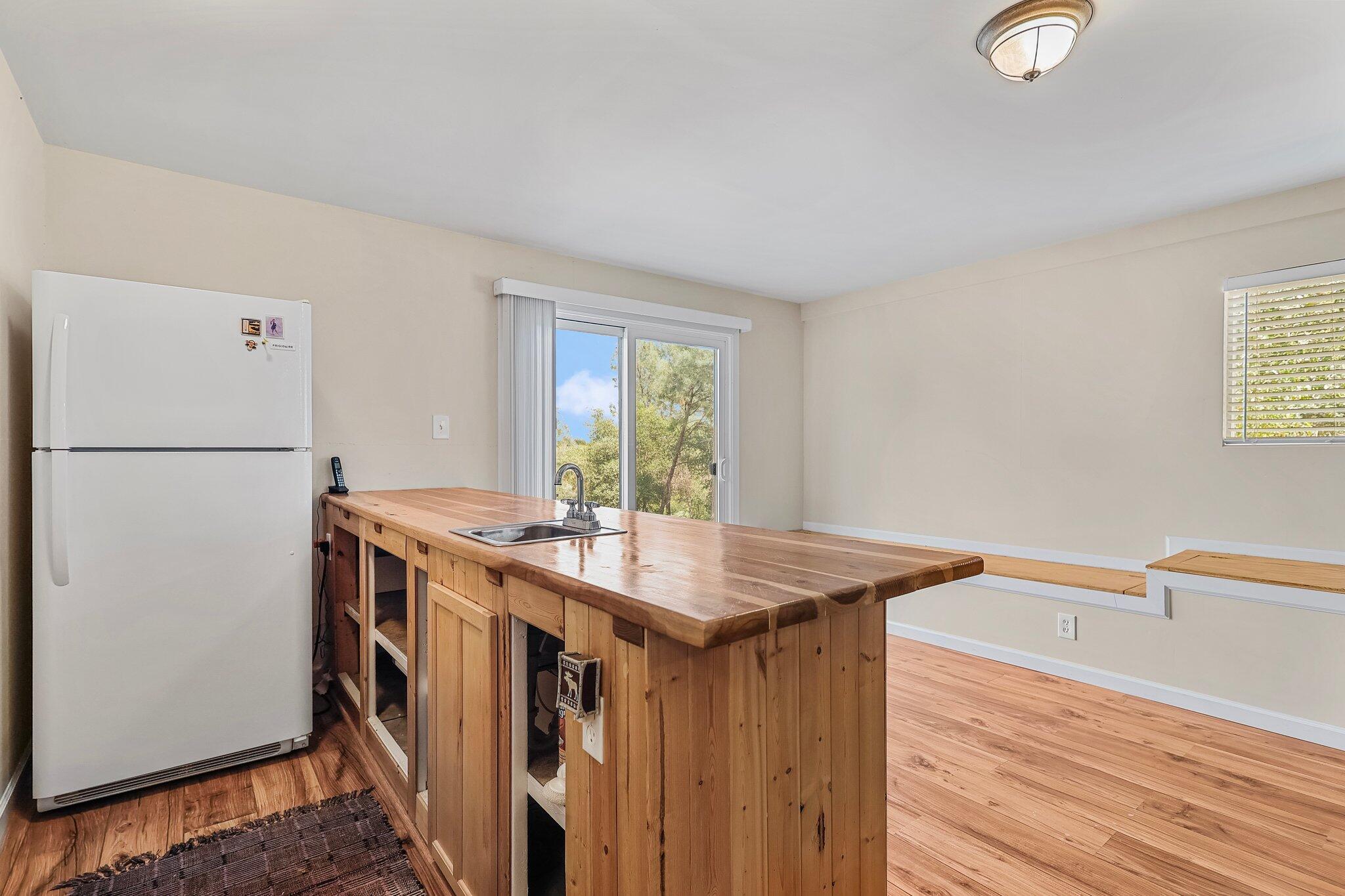 6949 Rector Creek Road Igo, CA 96047 - Photo 39 of 110 a kitchen with stainless steel appliances granite countertop a refrigerator a stove and a sink with wooden floor
