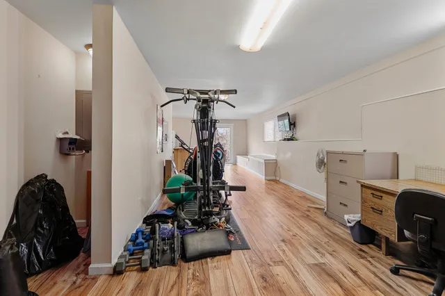 an aerial view of residential houses with outdoor space and trees