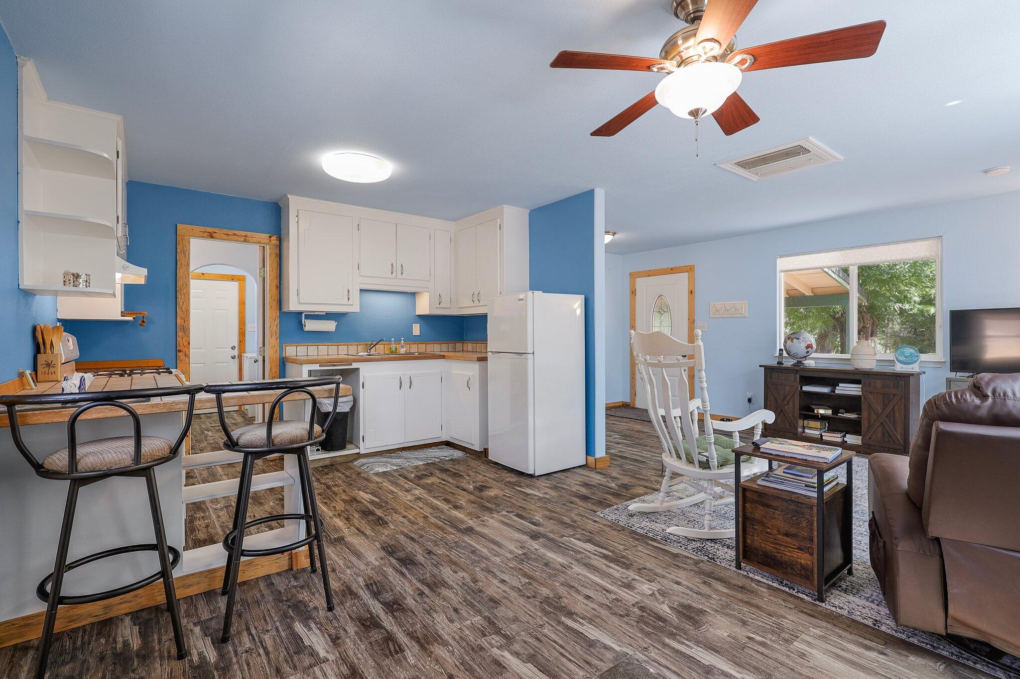 6949 Rector Creek Road Igo, CA 96047 - Photo 66 of 110 a kitchen with stainless steel appliances kitchen island granite countertop a stove top oven a sink dishwasher a dining table and chairs with wooden floor