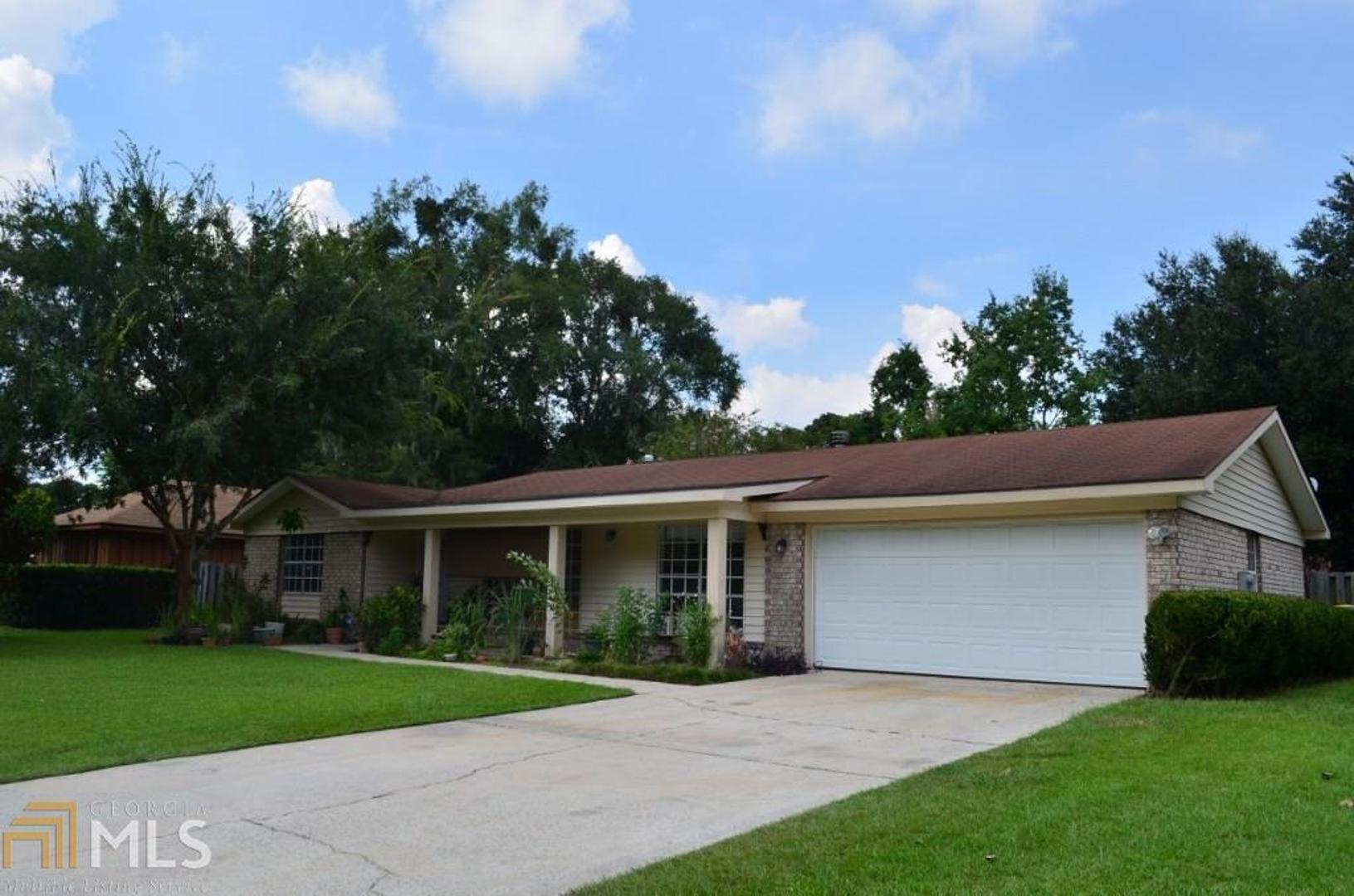 204 Leeds Gate Road Savannah, GA 31406 - Photo 1 of 1 a front view of a house with a yard and garage