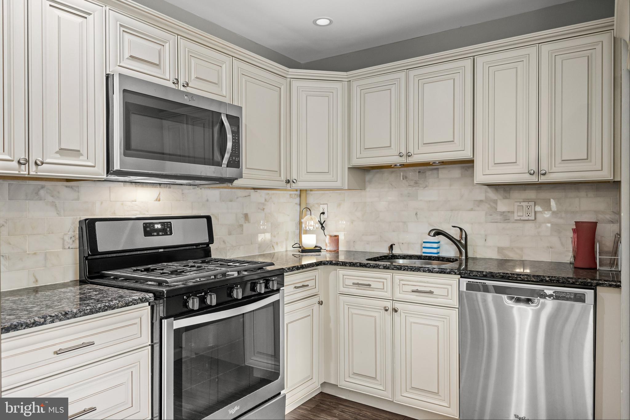 28 Windmill Clementon, NJ 08021 - Photo 11 of 28 a kitchen with granite countertop white cabinets and stainless steel appliances