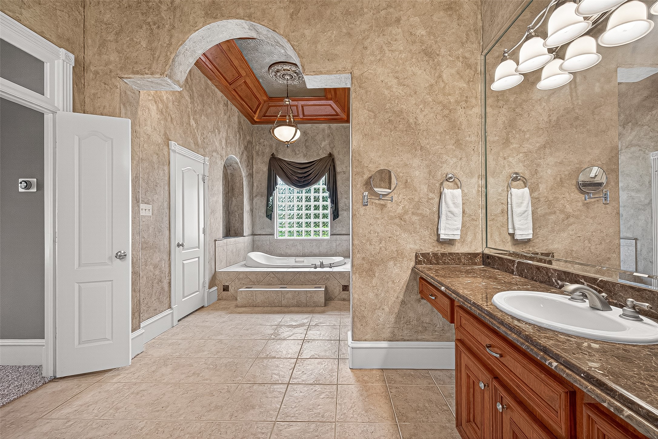 25626 Windy Isle Court Spring, TX 77389 - Photo 20 of 45 The room is accented with a decorative ceiling and stylish lighting, creating a serene and sophisticated atmosphere.