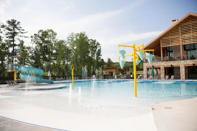an outdoor space with pool and trees