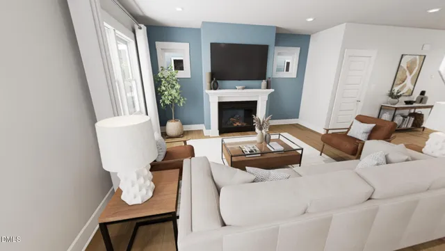 a living room with furniture a flat screen tv and a fireplace