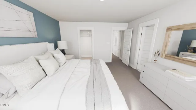 a large white bed in a white room