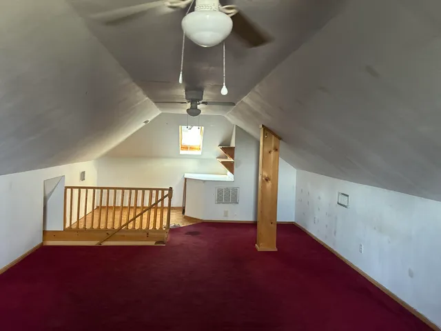 a view of a livingroom with a furniture wooden floor and chandelier