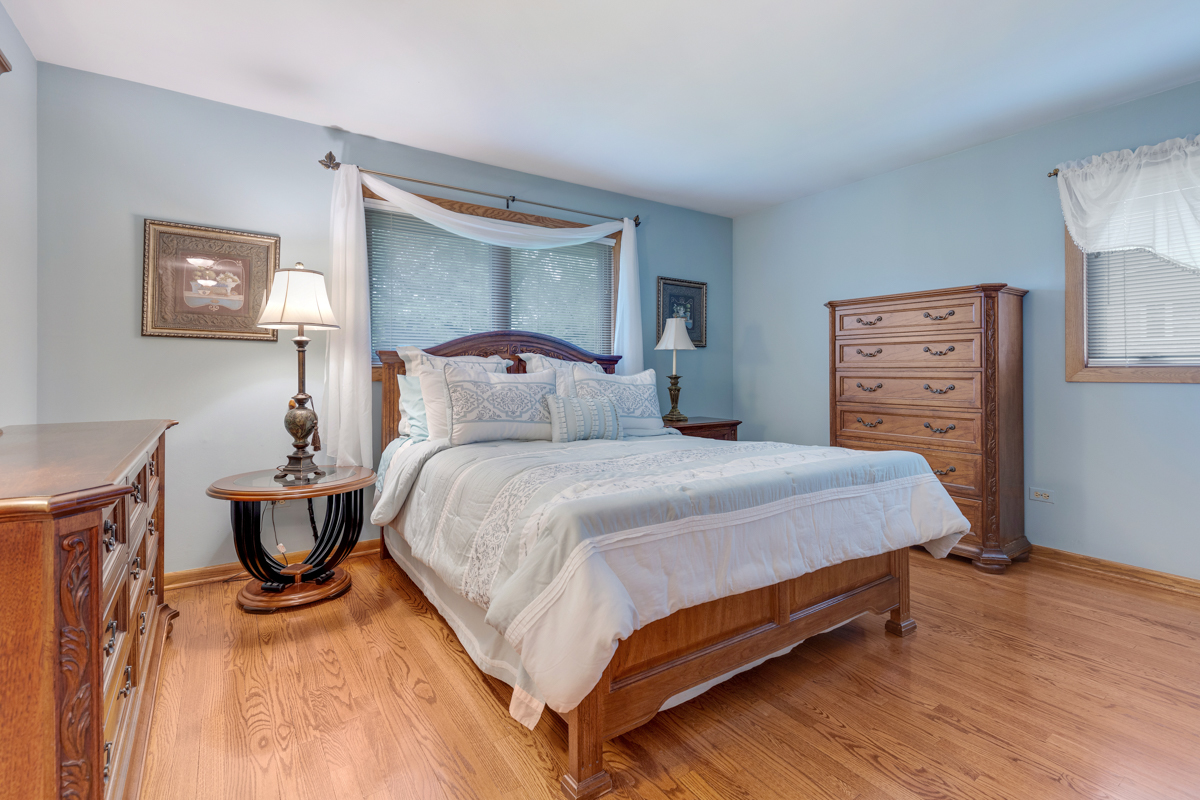 13031 Winnebago Road Palos Heights, IL 60463 - Photo 15 of 31 a bedroom with a bed and wooden floor