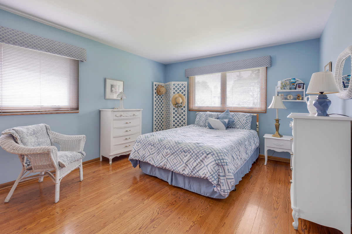 13031 Winnebago Road Palos Heights, IL 60463 - Photo 17 of 31 a bedroom with a bed and wooden floor