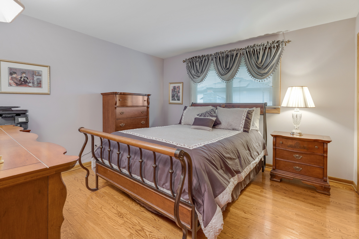 13031 Winnebago Road Palos Heights, IL 60463 - Photo 20 of 31 a bedroom with a bed and a dresser