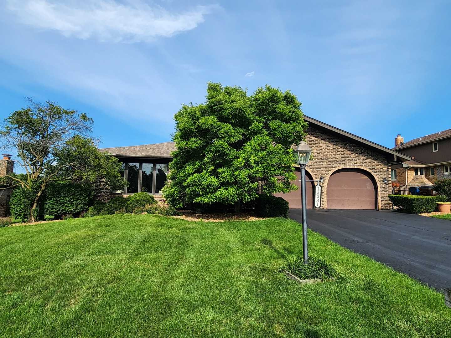 13031 Winnebago Road Palos Heights, IL 60463 - Photo 2 of 31 a front view of a house with garden