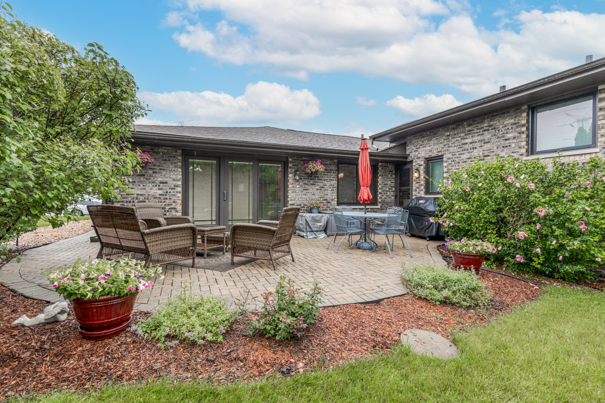 13031 Winnebago Road Palos Heights, IL 60463 - Photo 30 of 31 a view of a patio with table and chairs potted plants