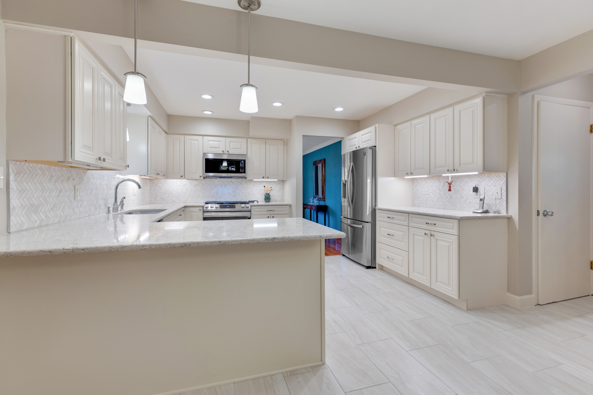13031 Winnebago Road Palos Heights, IL 60463 - Photo 5 of 31 a kitchen with kitchen island granite countertop a sink stainless steel appliances and white cabinets