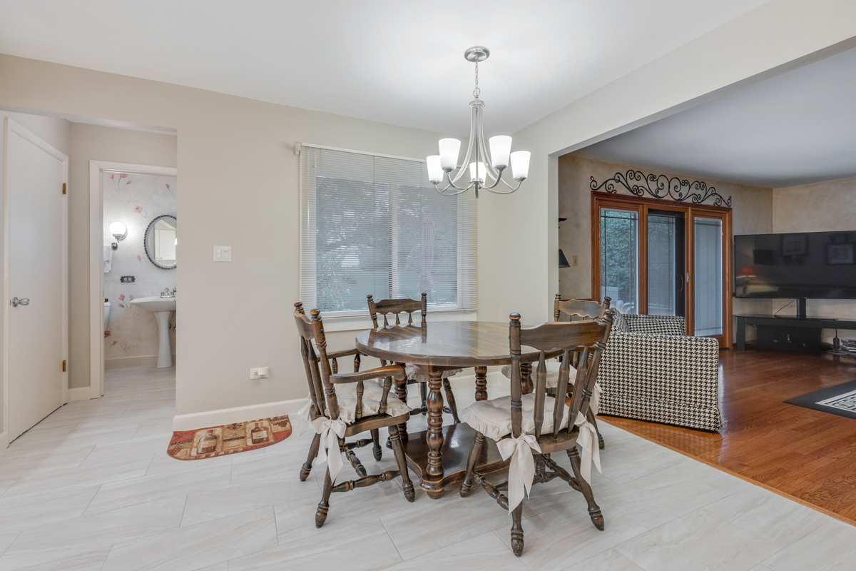 13031 Winnebago Road Palos Heights, IL 60463 - Photo 8 of 31 a view of a dining room with furniture and wooden floor